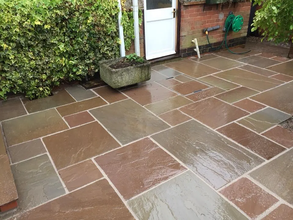 Autumn brown Indian sandstone patio in a walled garden