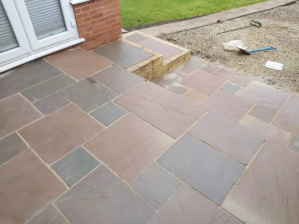 Autumn brown sandstone patio with steps and a gravel border