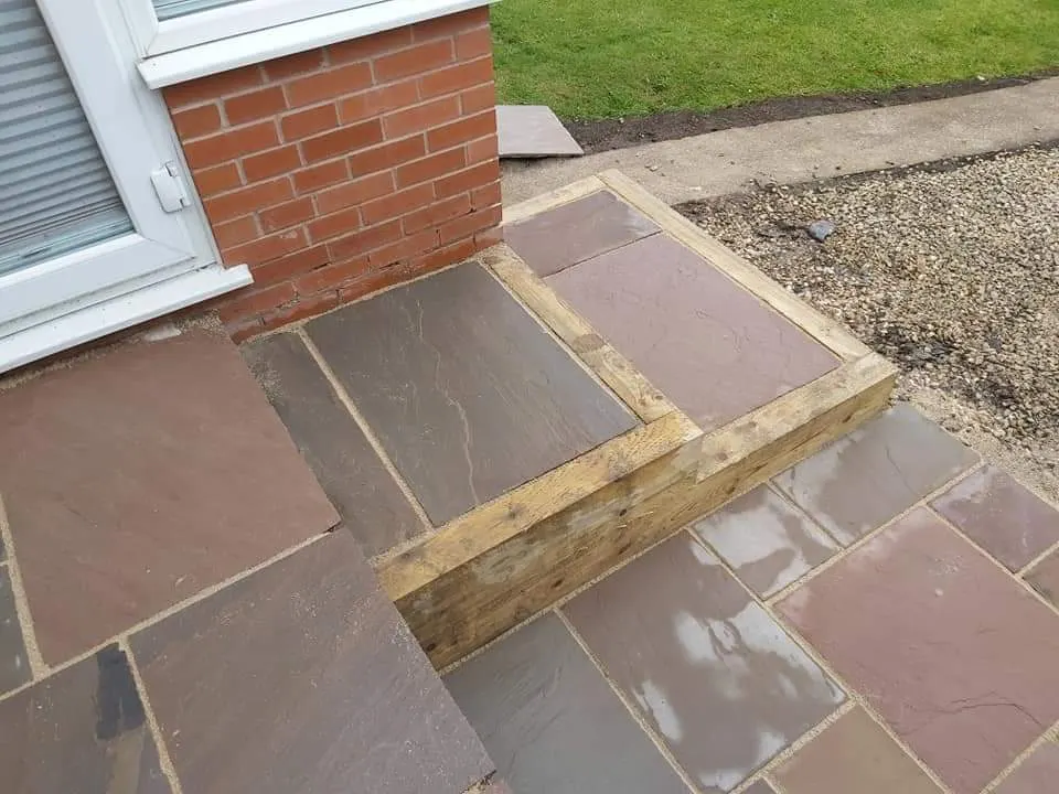 Autumn brown sandstone patio on two levels with sleepers