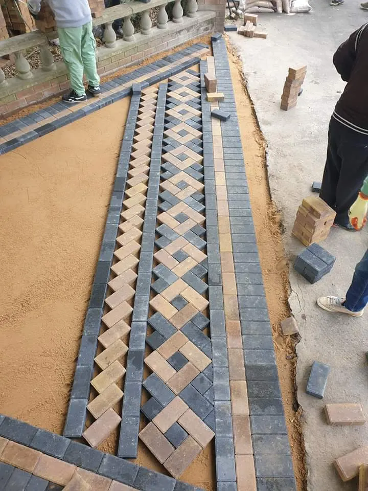 Decorative block paving border being laid