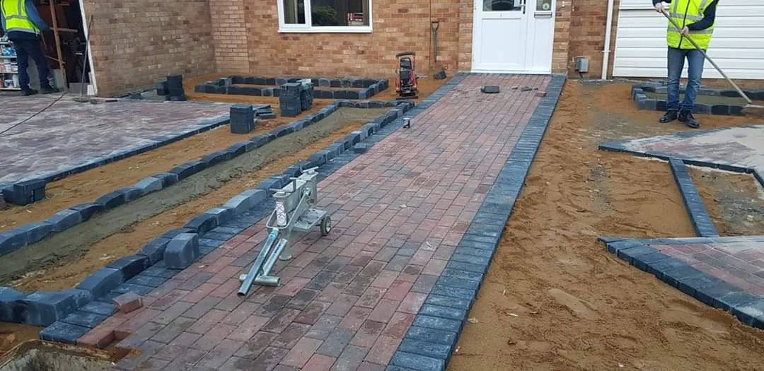 Block paving path and edging being laid across a frontage