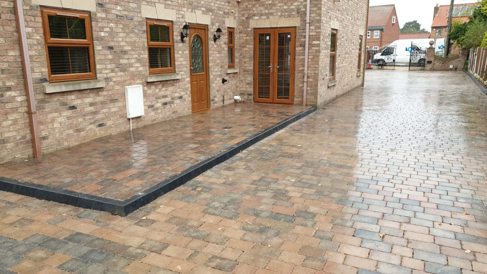 Brindle block paving driveway with a charcoal border beside a new-build