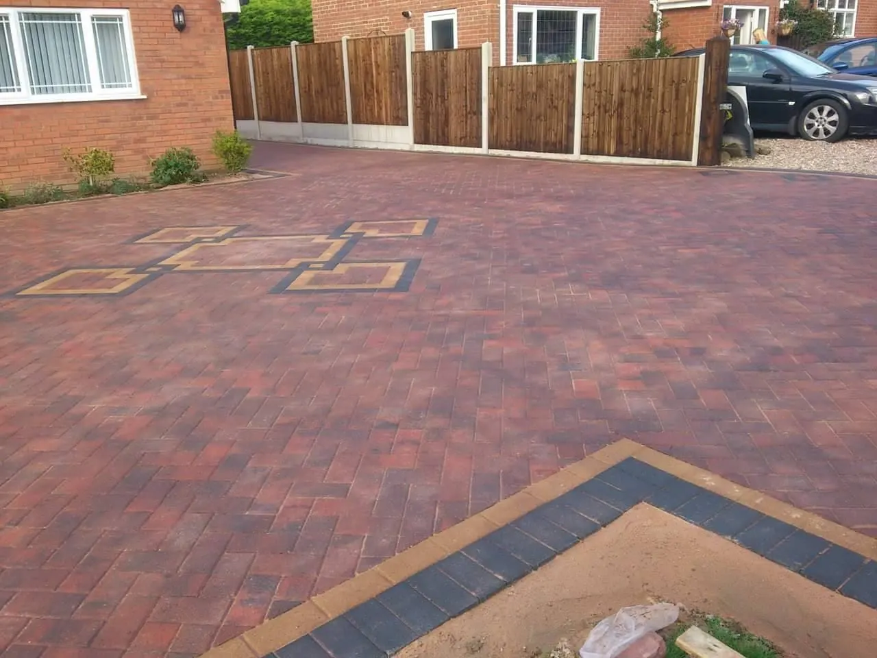 Brindle block paving driveway with square features and a charcoal border