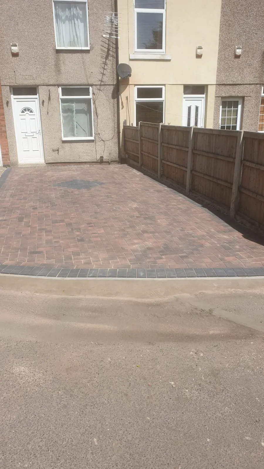 Brindle block paving driveway in front of terraced houses