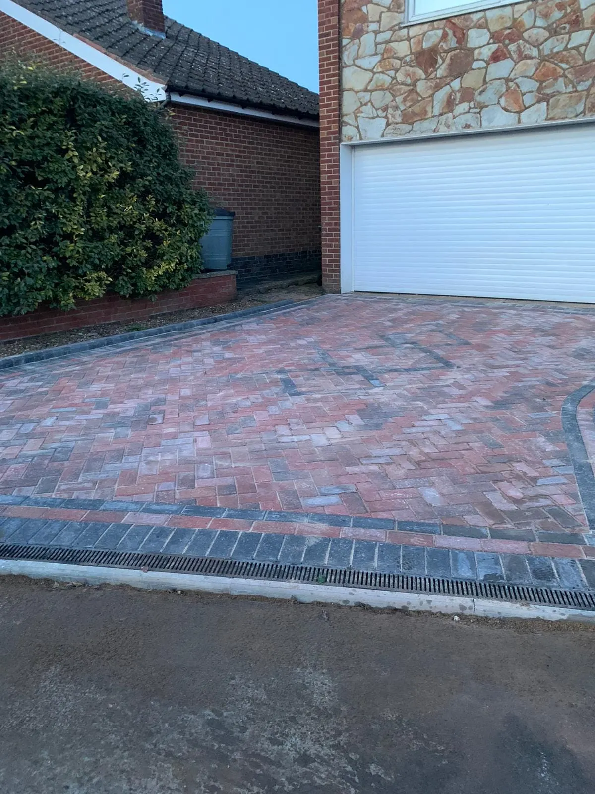 Brindle block paving driveway with a charcoal border up to a garage