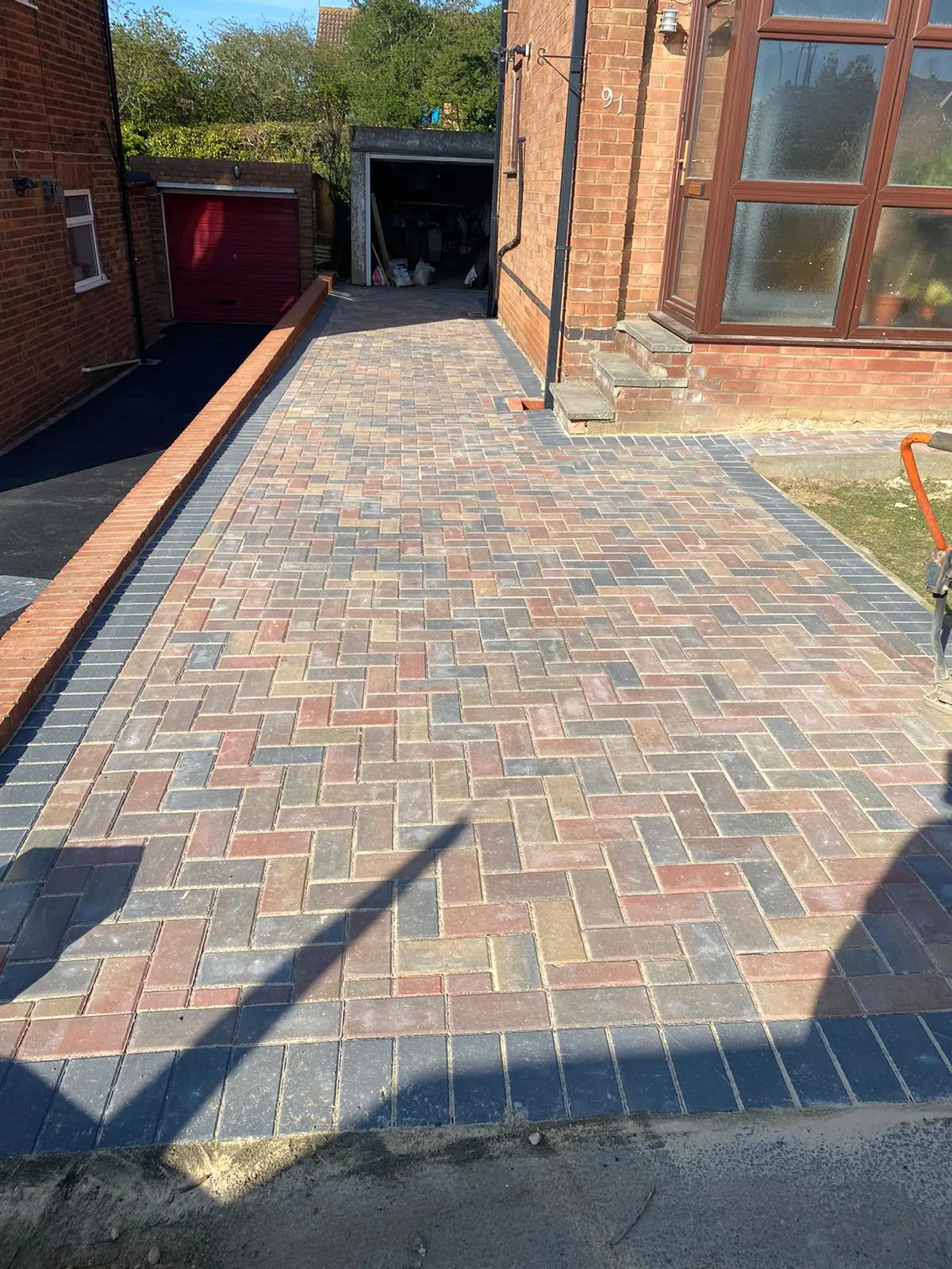 Brindle block paving path along the side of a house