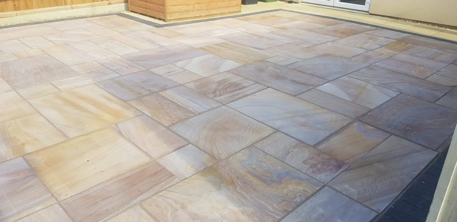 Buff sandstone patio slabs with natural veining