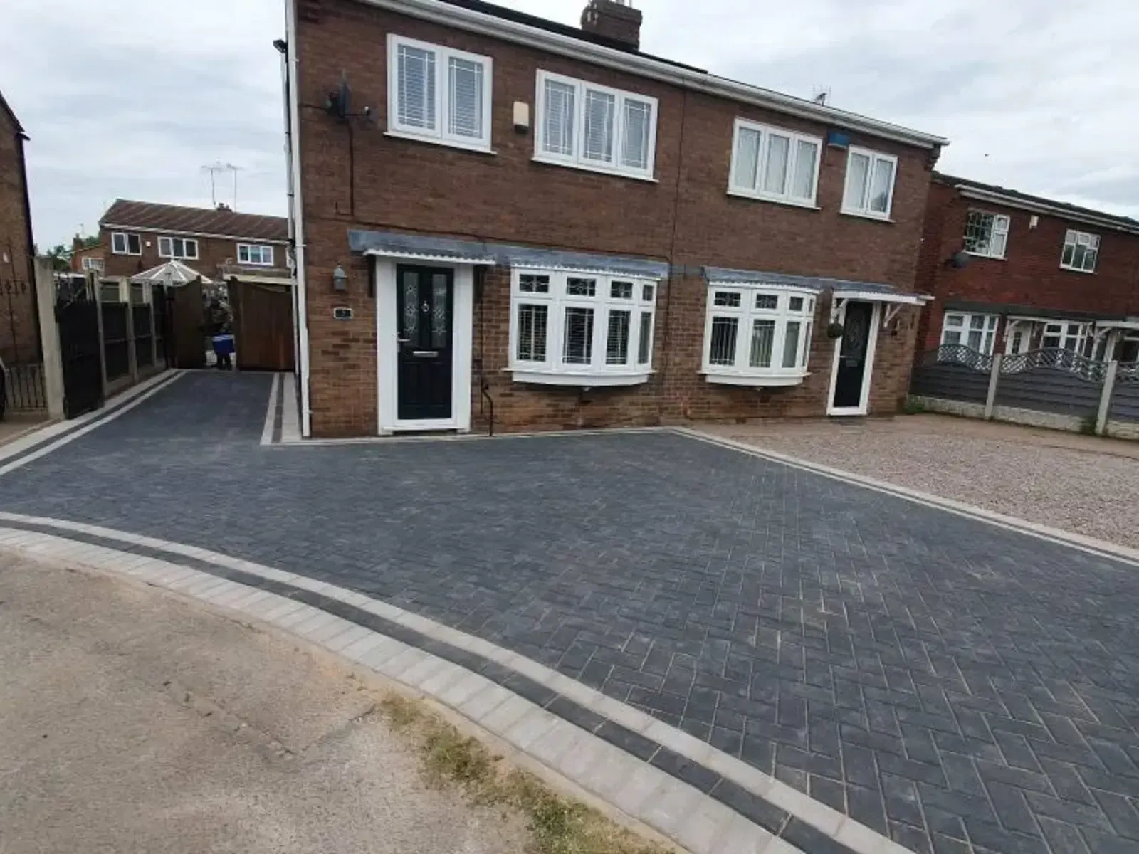 Charcoal block paving driveway in front of a semi-detached house