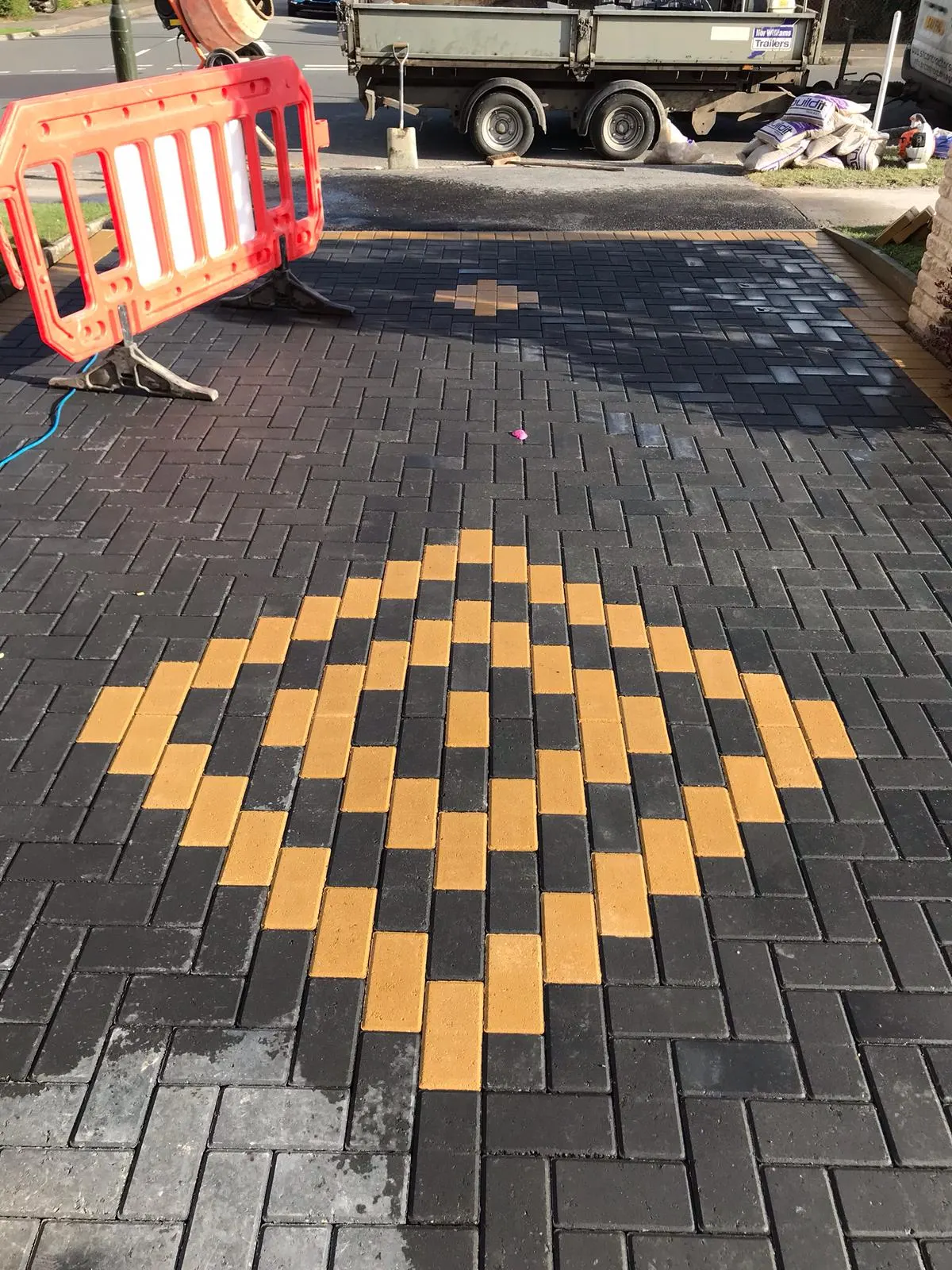 Charcoal block paving with an orange diamond feature