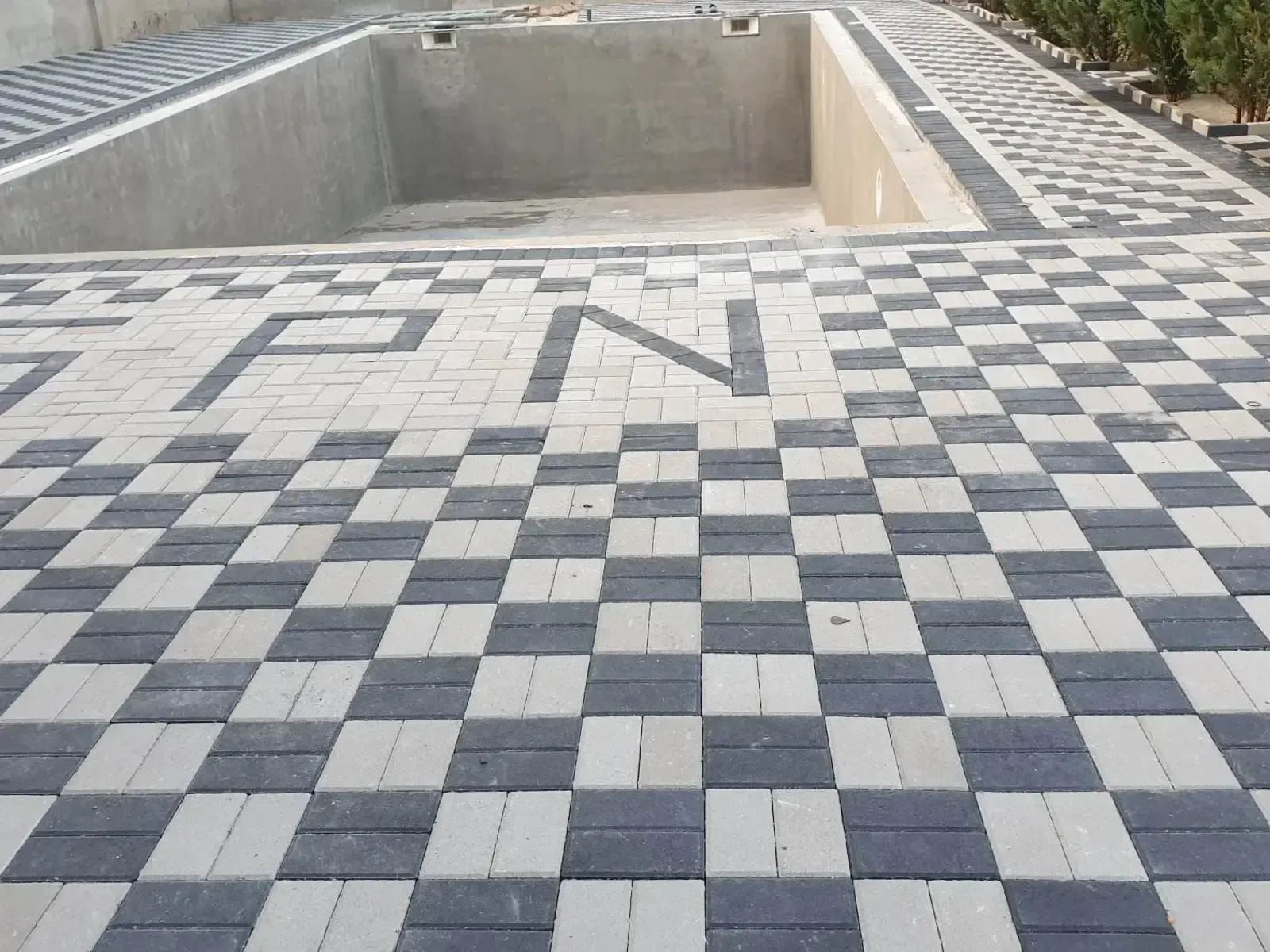 Checkerboard block paving around a swimming pool