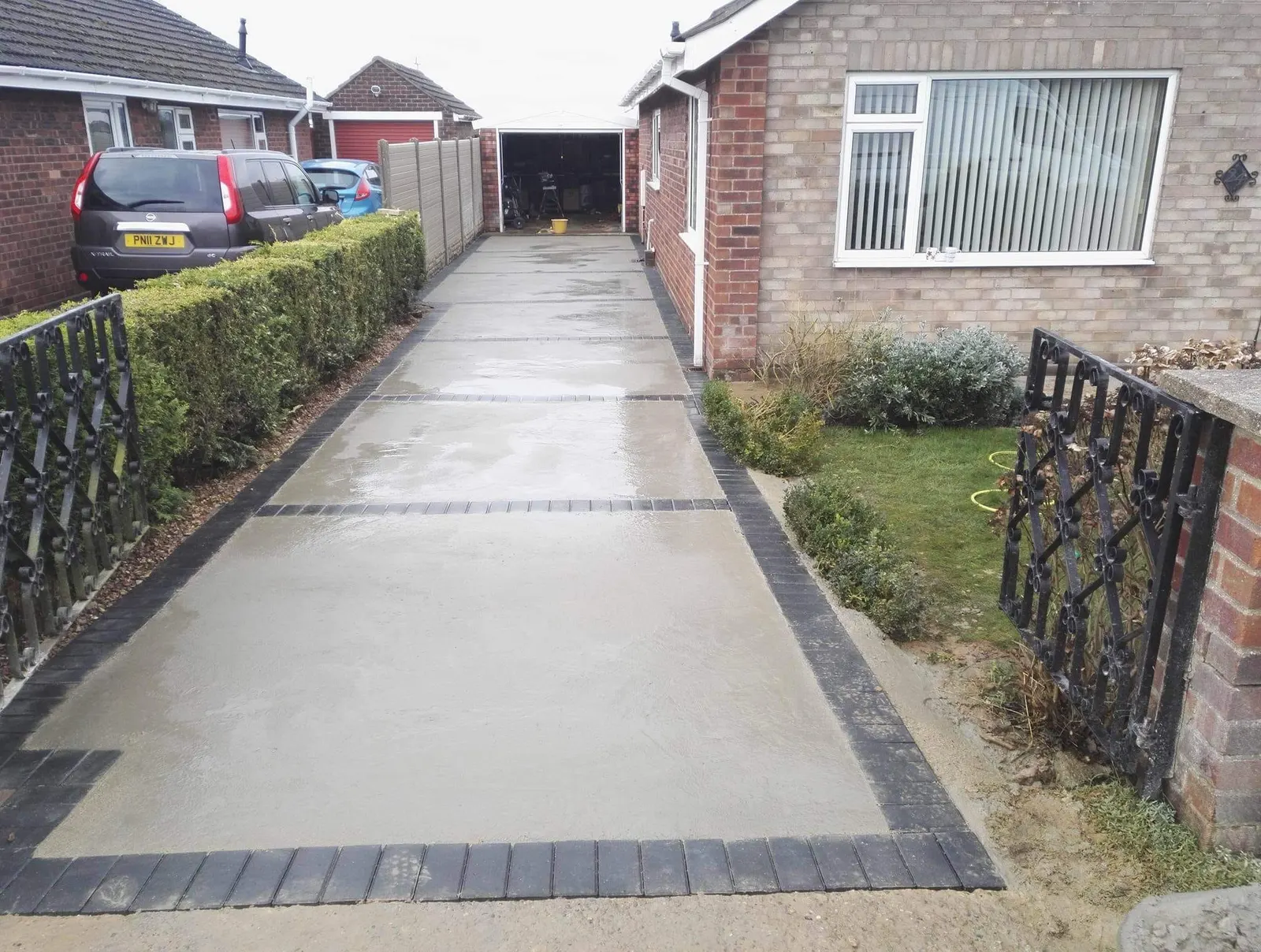 Concrete driveway with a charcoal block paving border