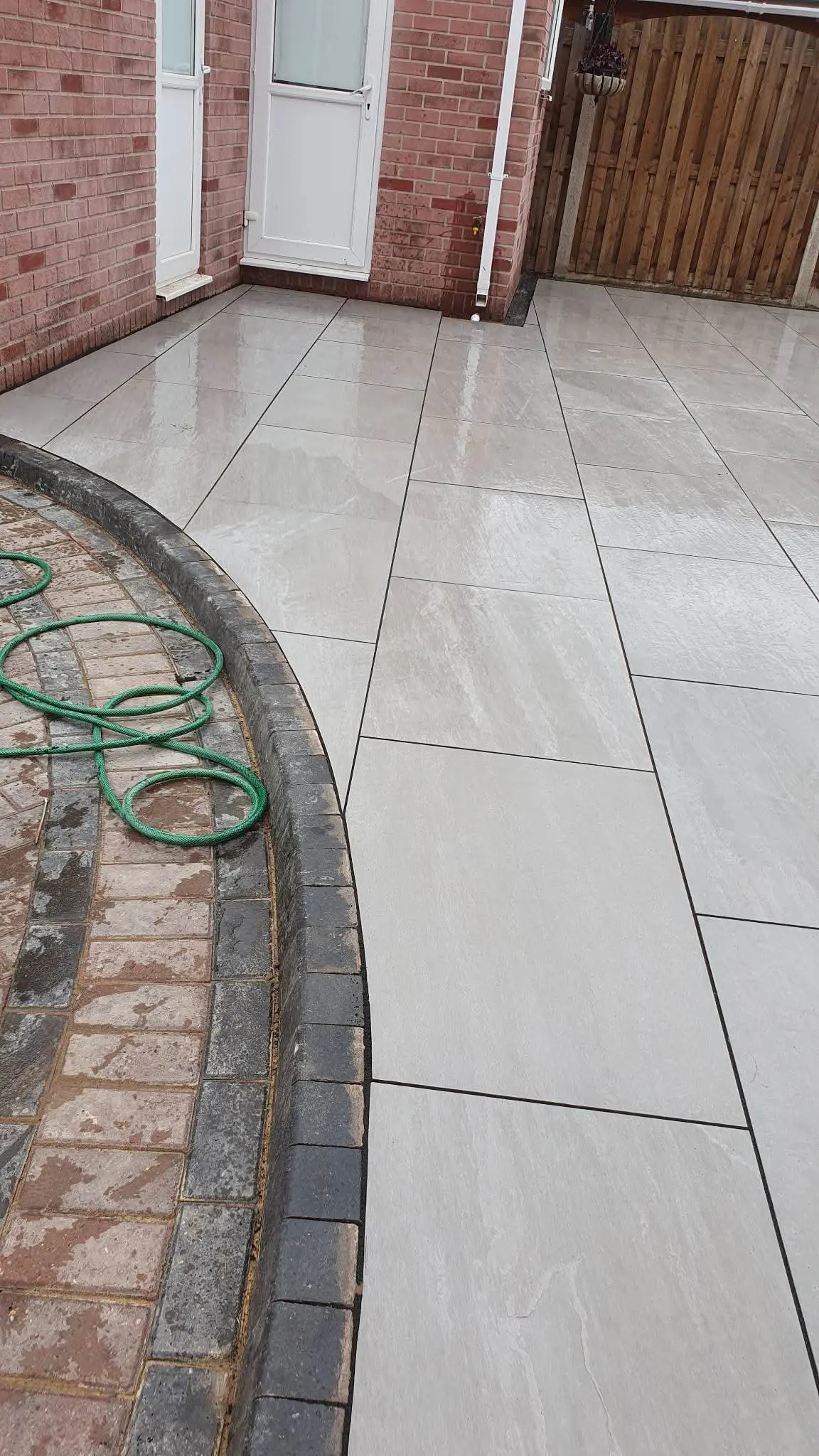 Cream porcelain patio with a curved block paving edge