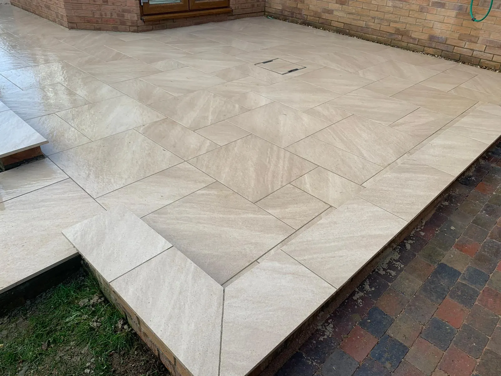 Cream porcelain patio slabs with narrow joints