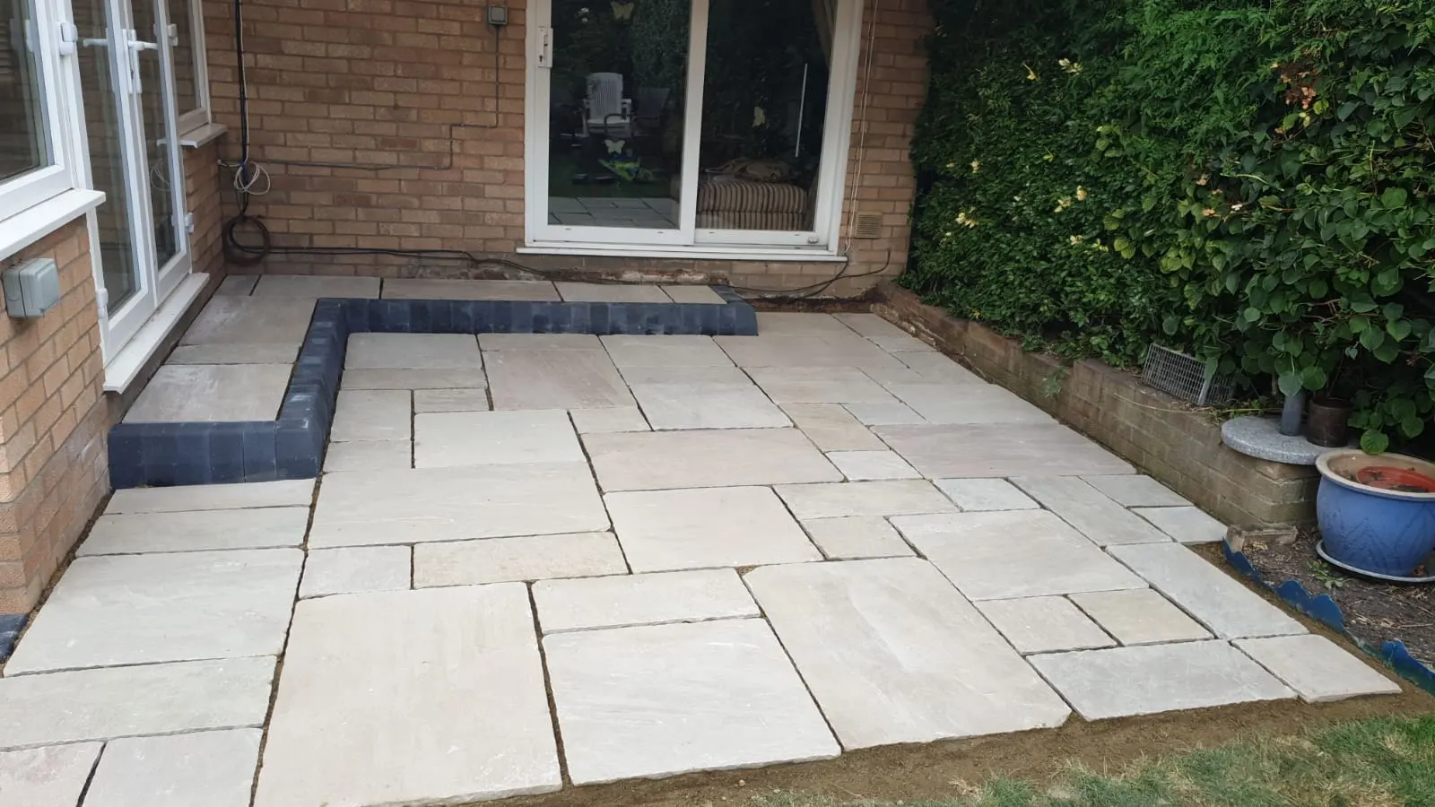 Cream porcelain patio outside sliding doors with a charcoal edge