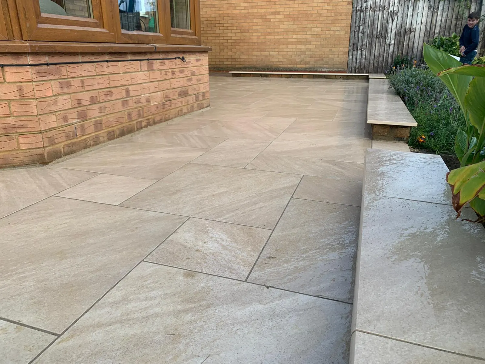Cream porcelain patio with a step and a planted border