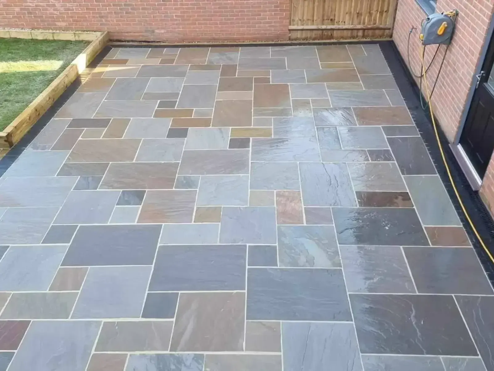 Grey Indian sandstone patio in mixed-size slabs