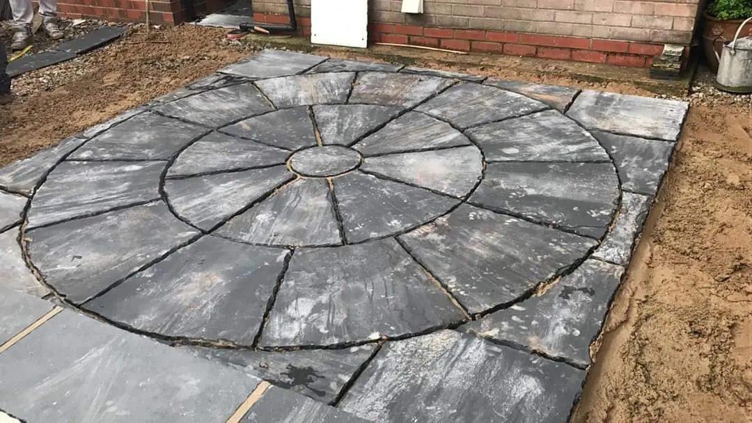 Grey patio circle feature being laid