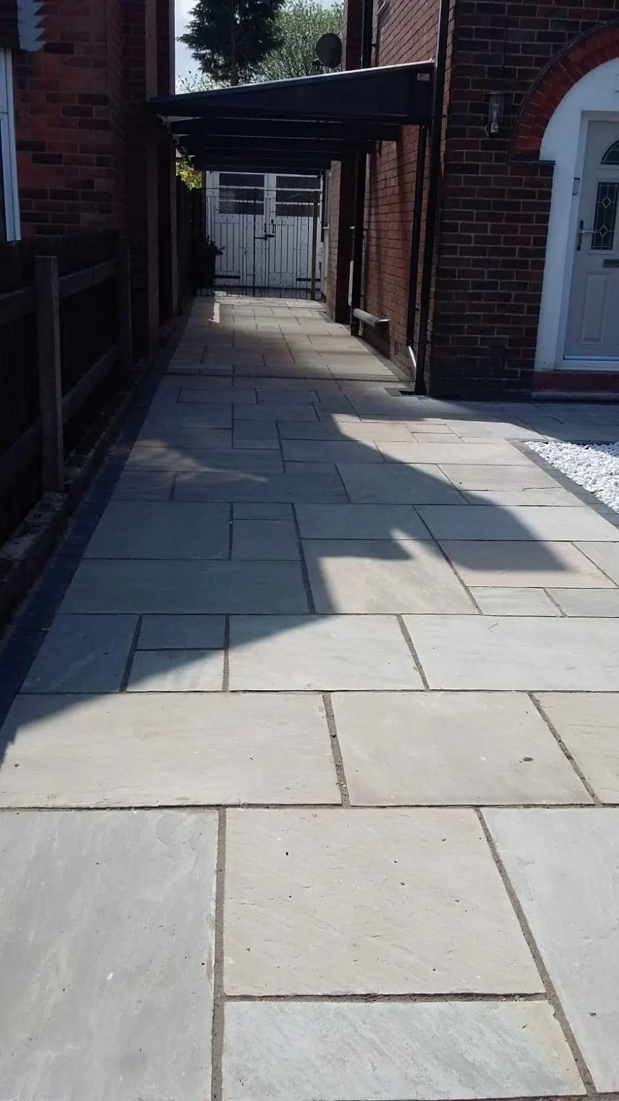 Grey porcelain path along the side of a terraced house
