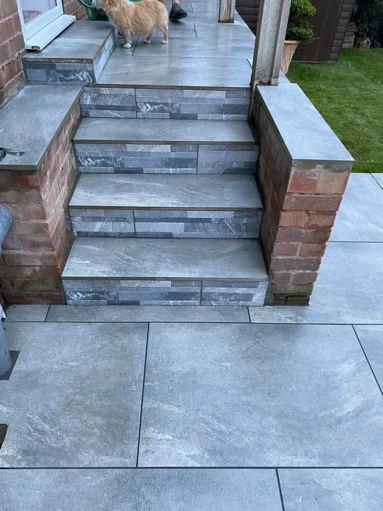 Grey porcelain steps between brick piers