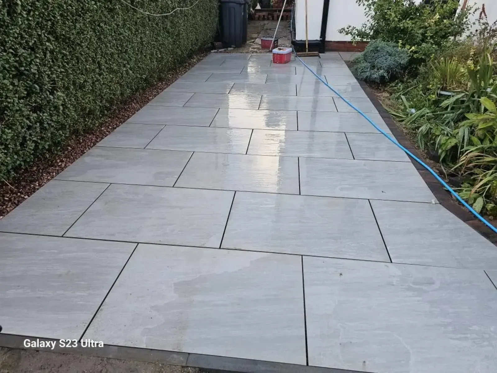Light grey porcelain path along the side of a house