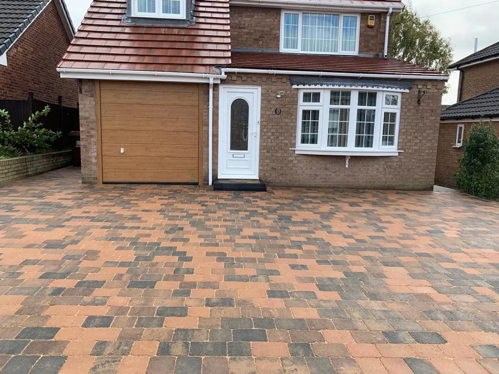 Multicolour block paving driveway in front of a detached house