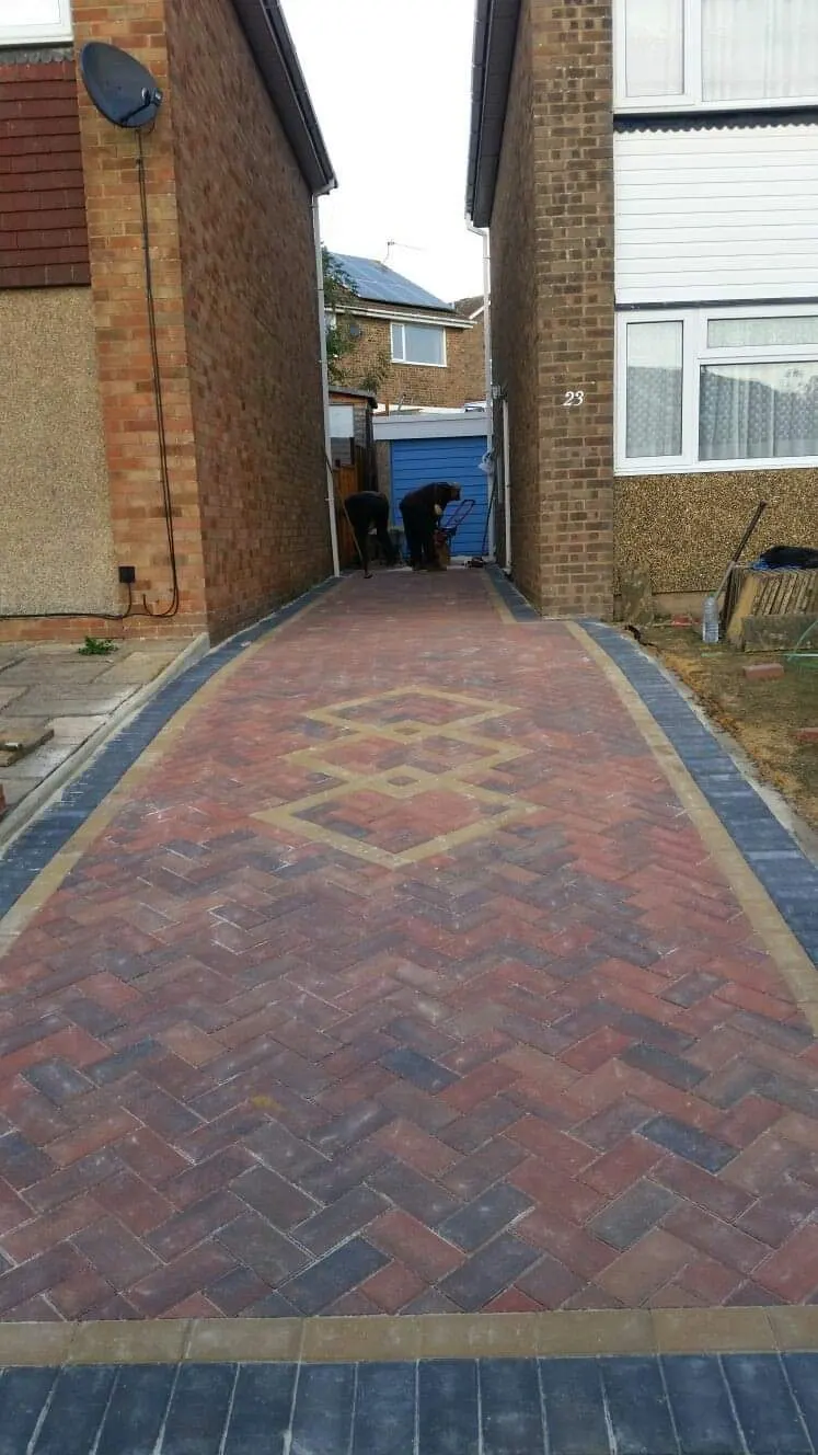 Narrow red block paving driveway with a diamond inset