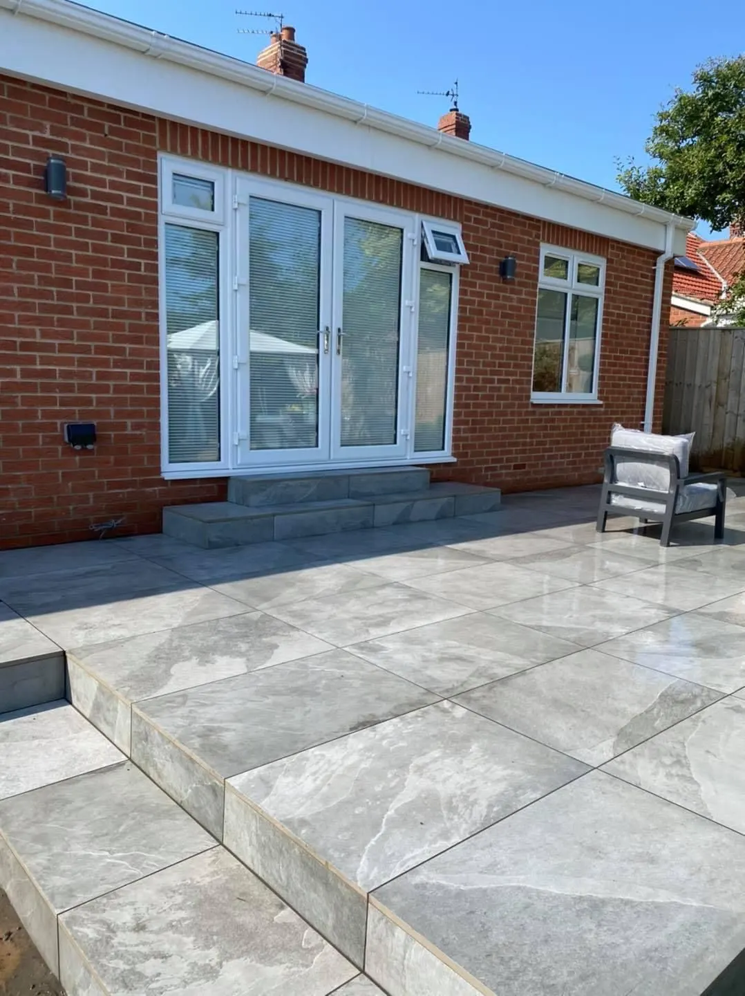 Porcelain patio outside the French doors of a bungalow