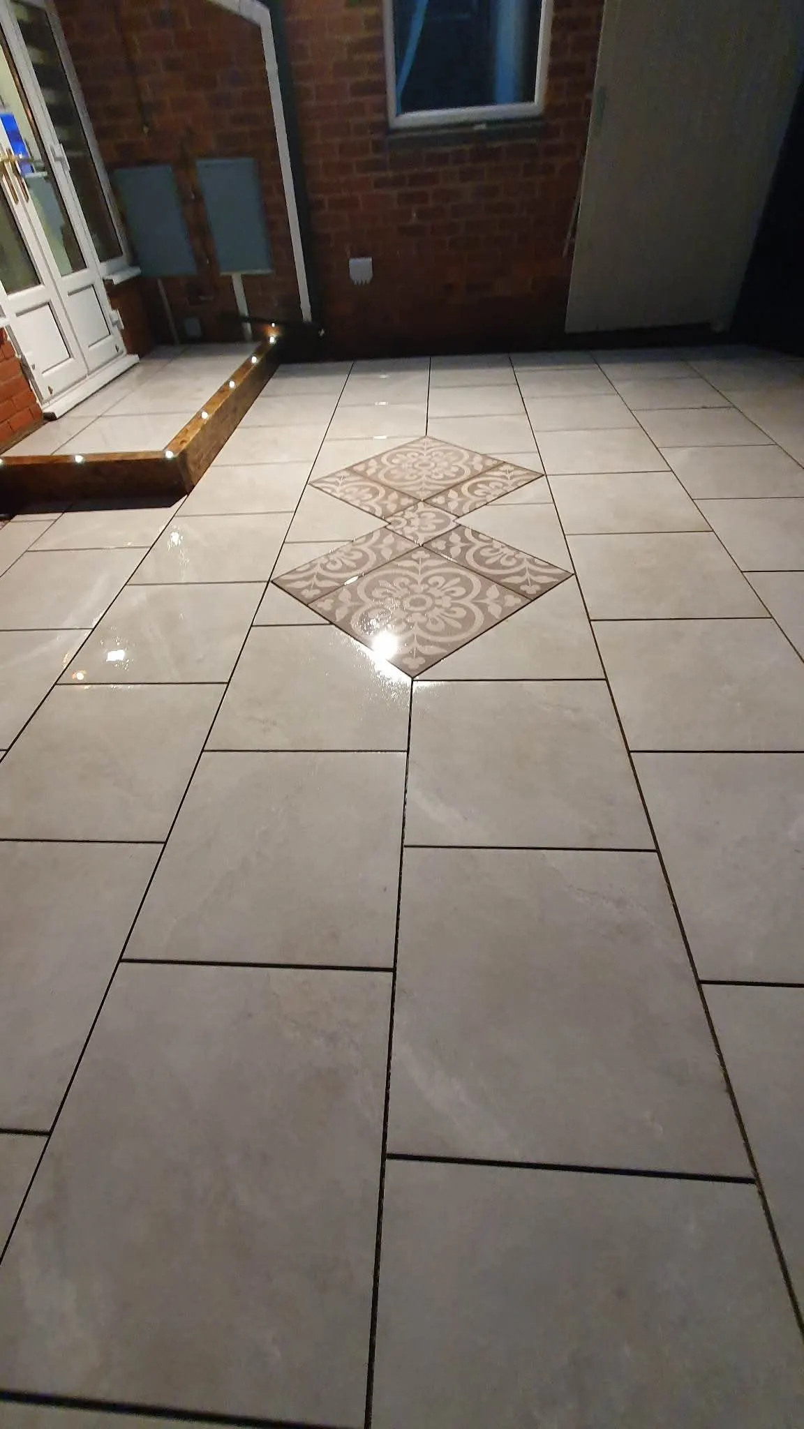 Porcelain patio with a diamond inset and deck lights
