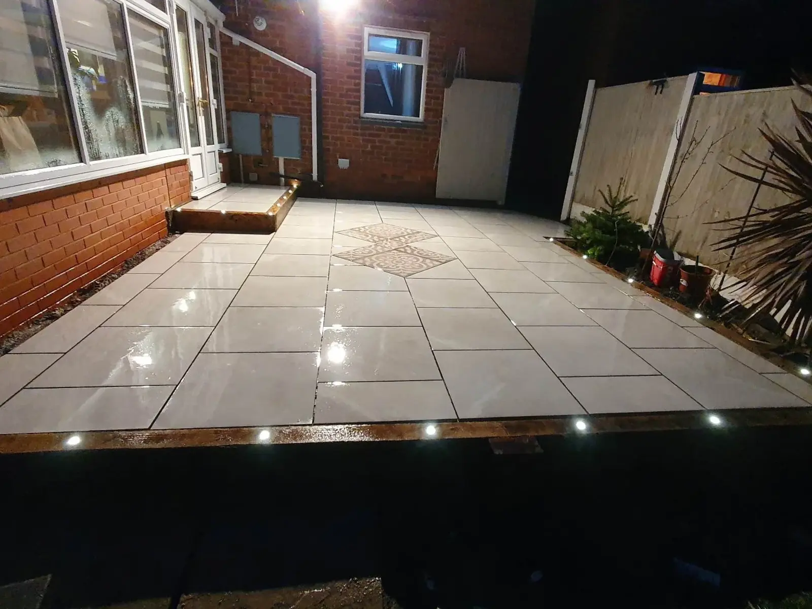 Porcelain patio lit by LED deck lights at night