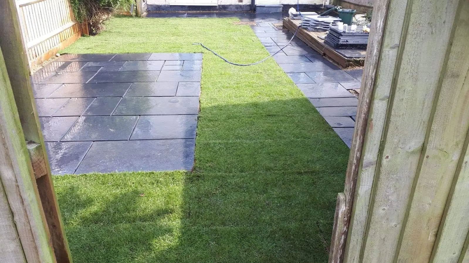 Porcelain slab path beside a lawn in a side garden