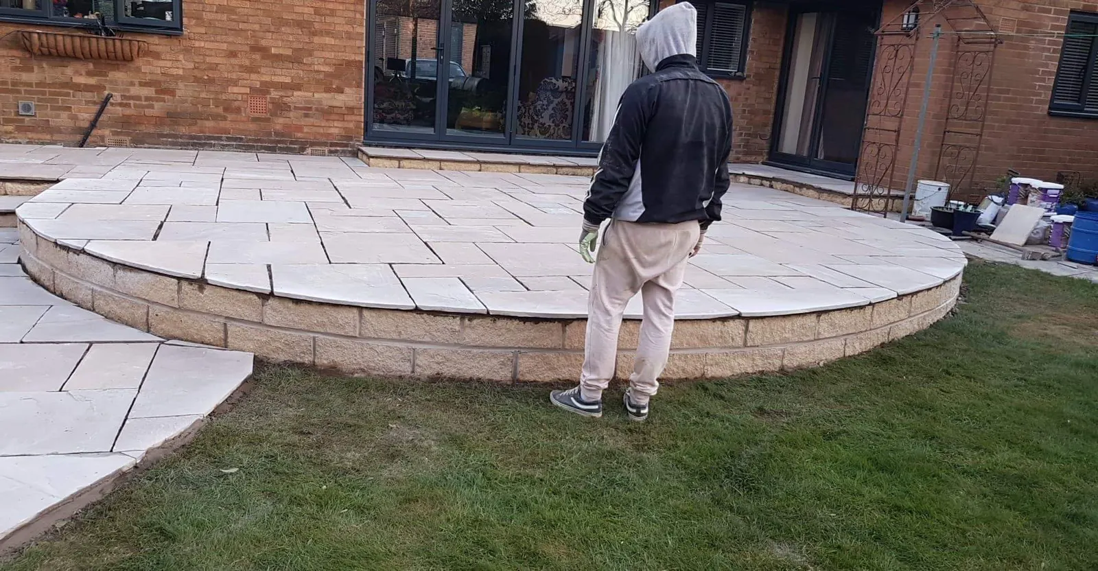 Raised circular porcelain patio above a lawn