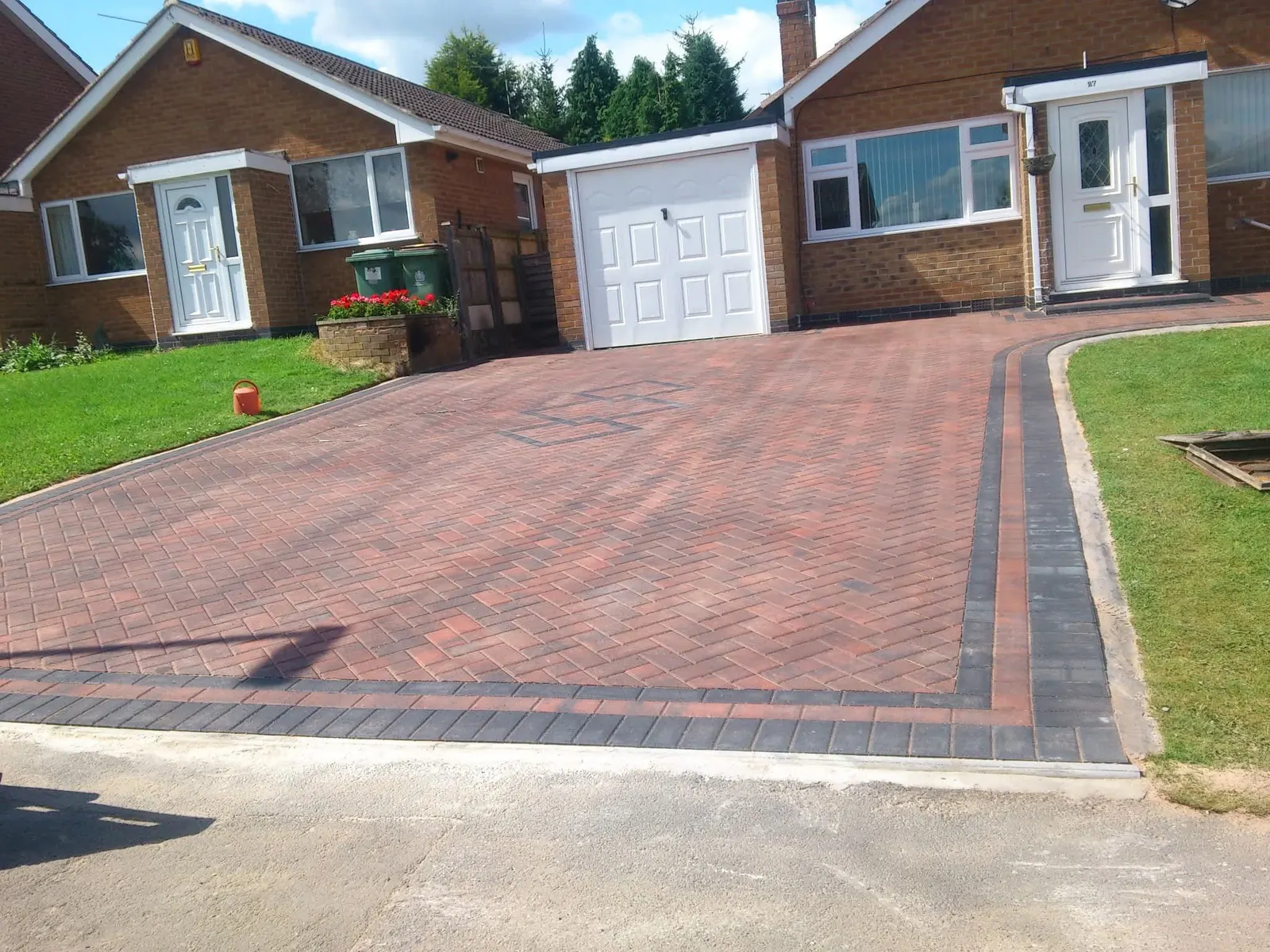 Red block paving driveway in herringbone with a charcoal border