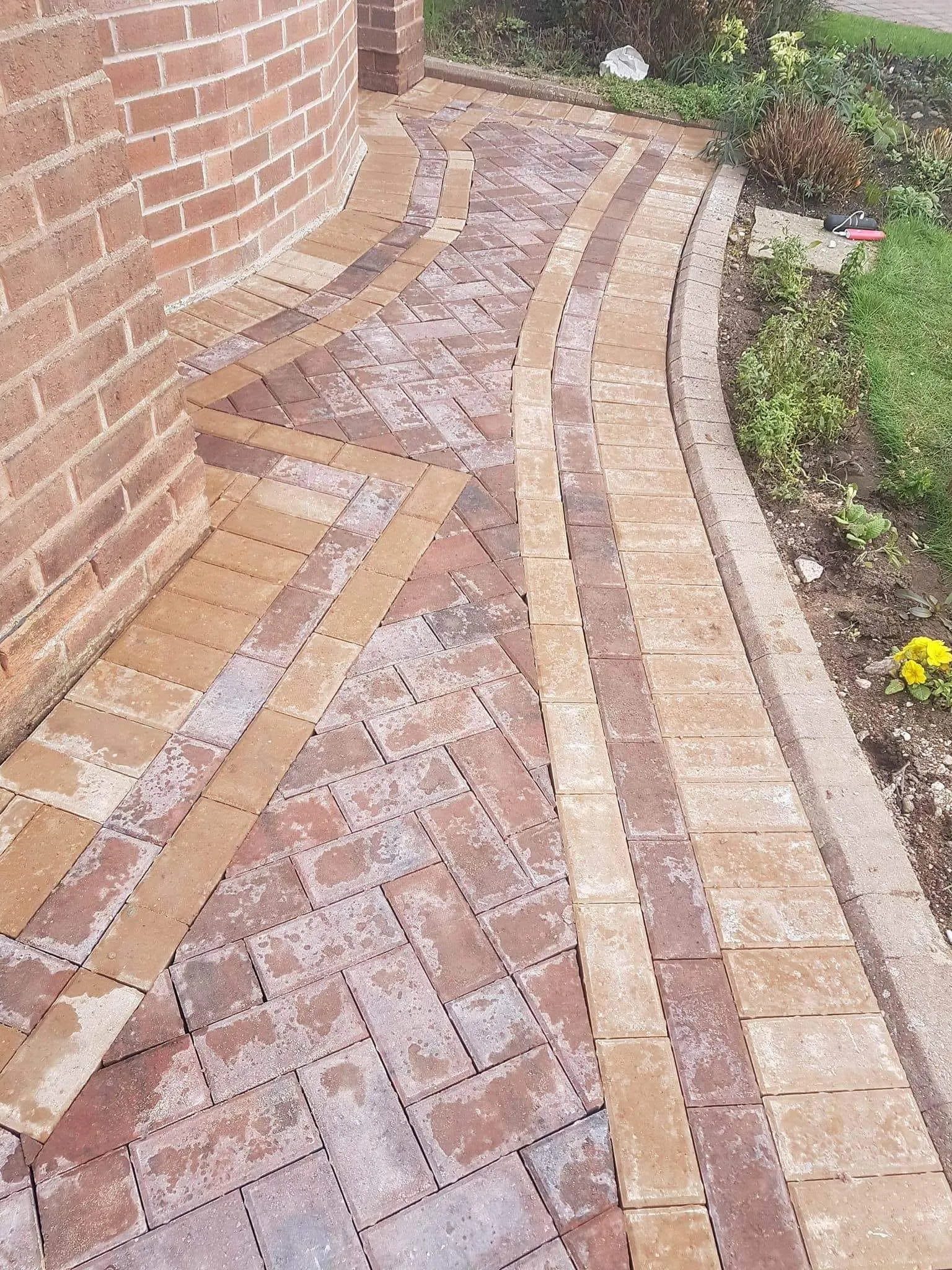 Red block paving path with buff borders