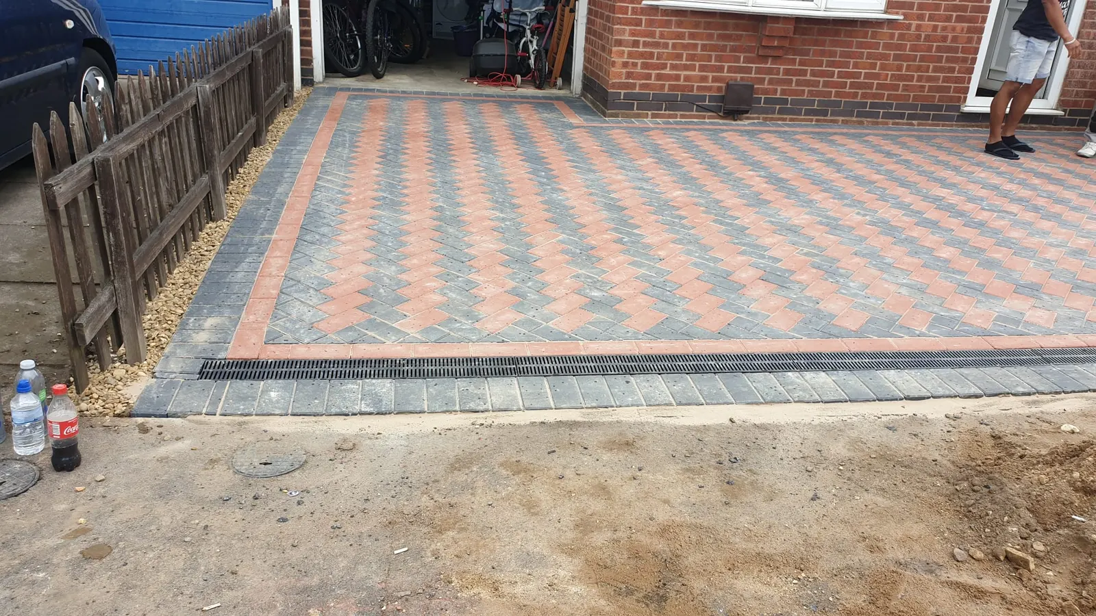 Red and charcoal block paving driveway nearly finished