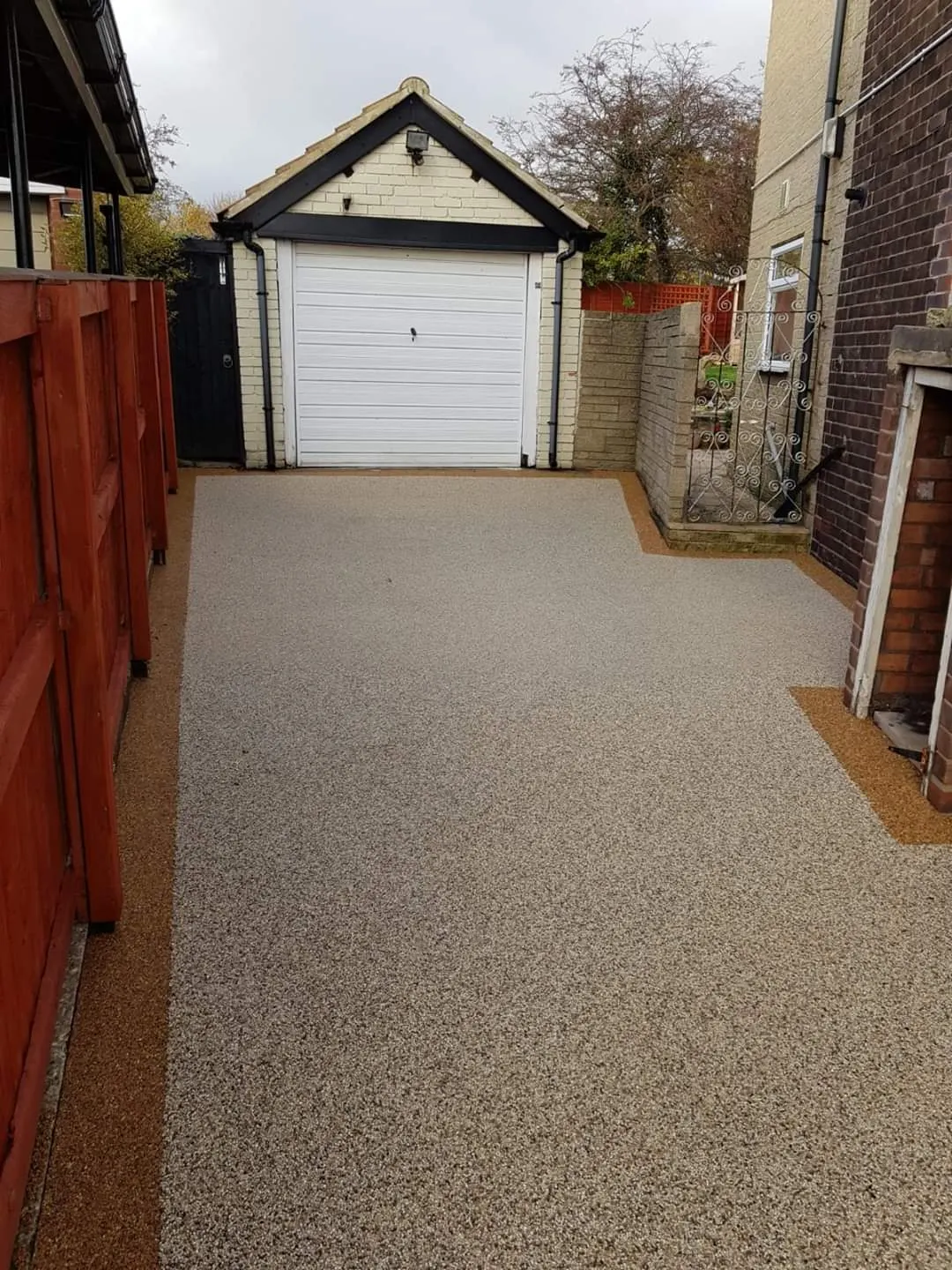 Resin bound driveway down the side of a house to a garage
