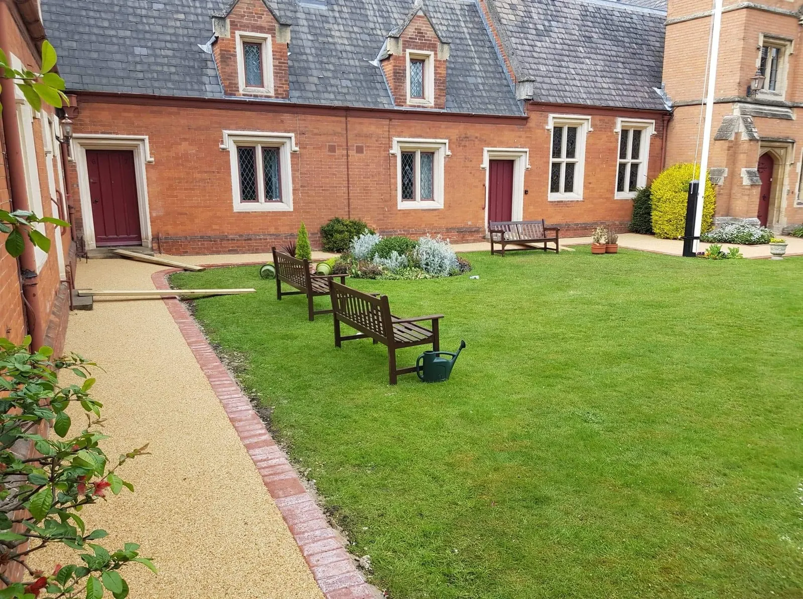 Resin bound path with brick edging through a courtyard garden