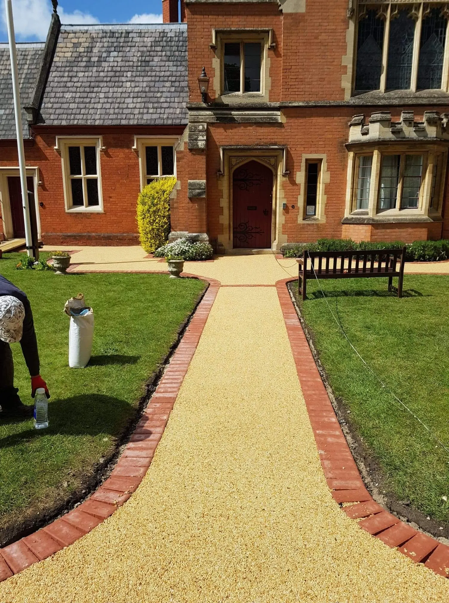 Resin bound path with red brick edging between two lawns