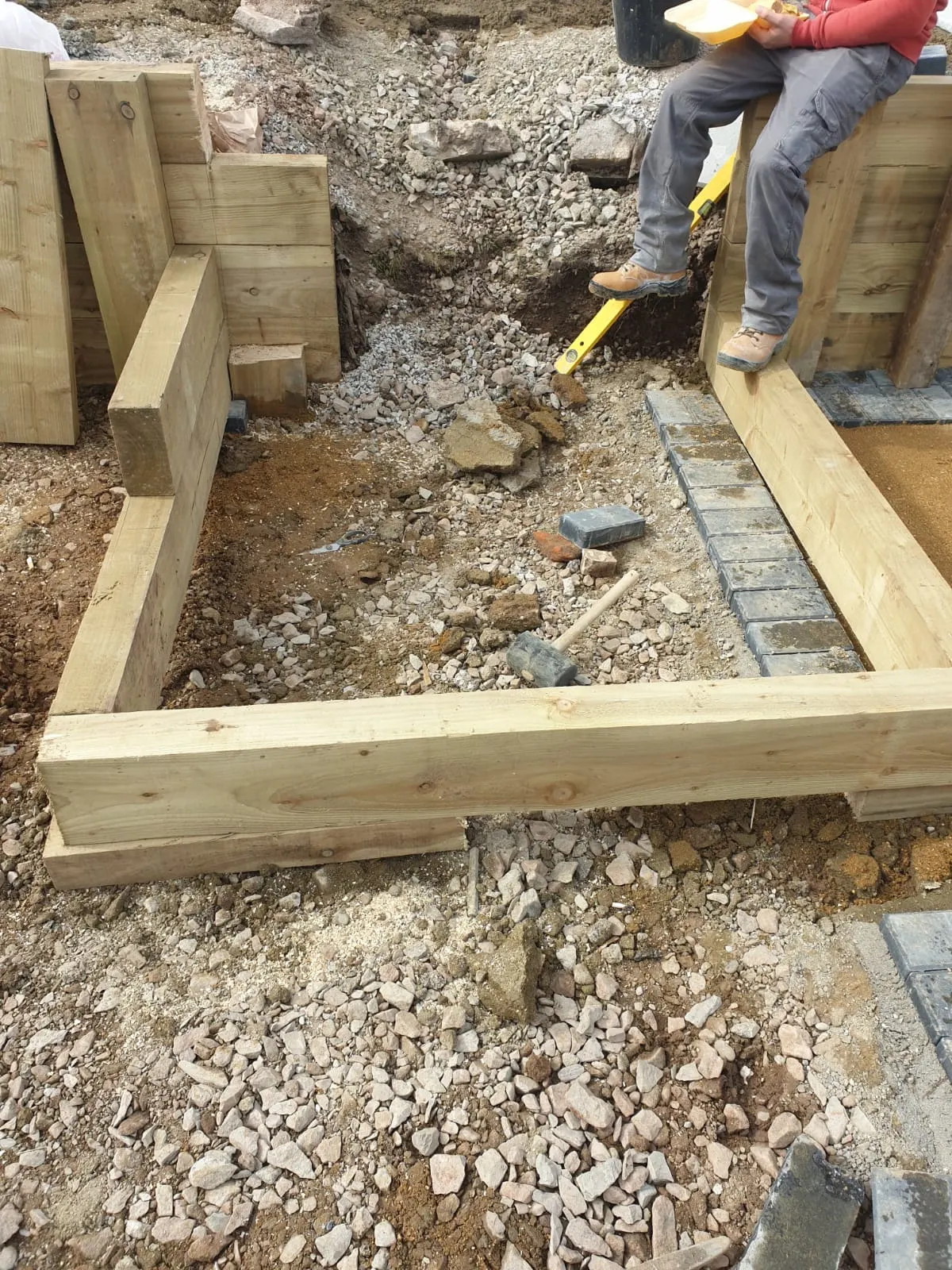 Timber sleeper retaining wall under construction