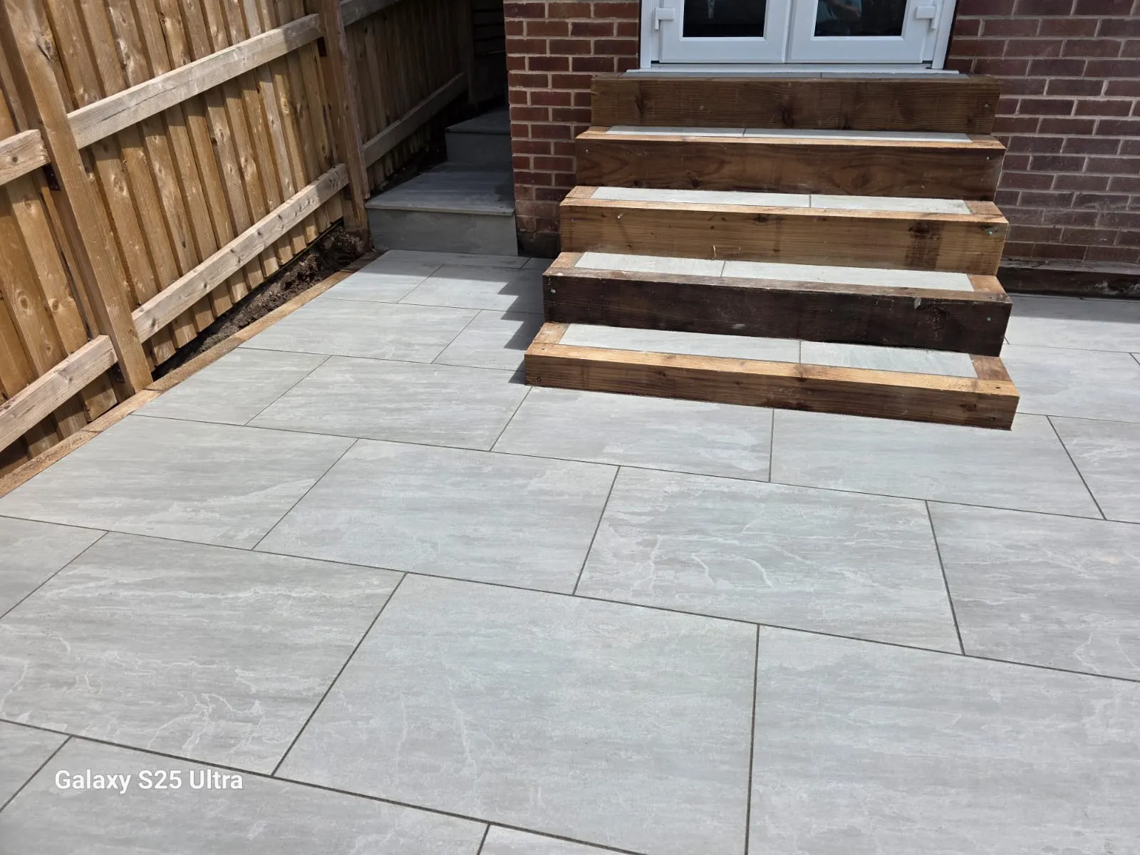 Sleeper steps with porcelain treads up to French doors