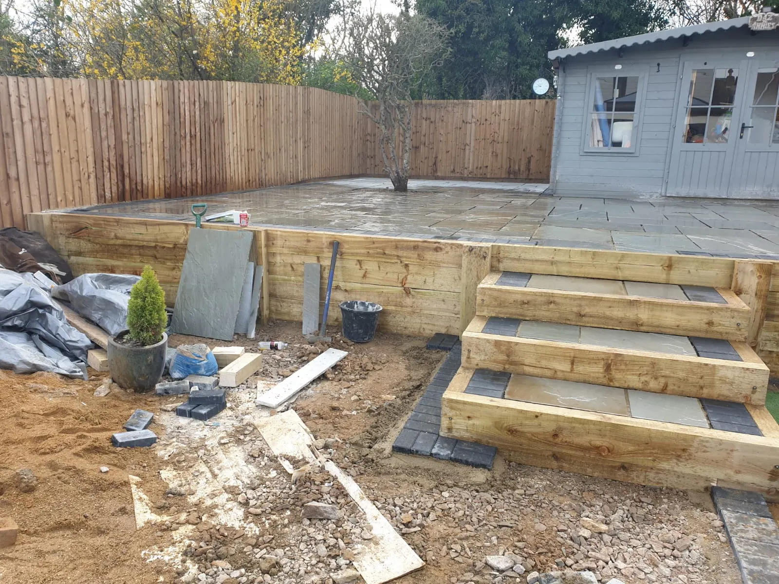 Sleeper steps up to a raised patio and garden room
