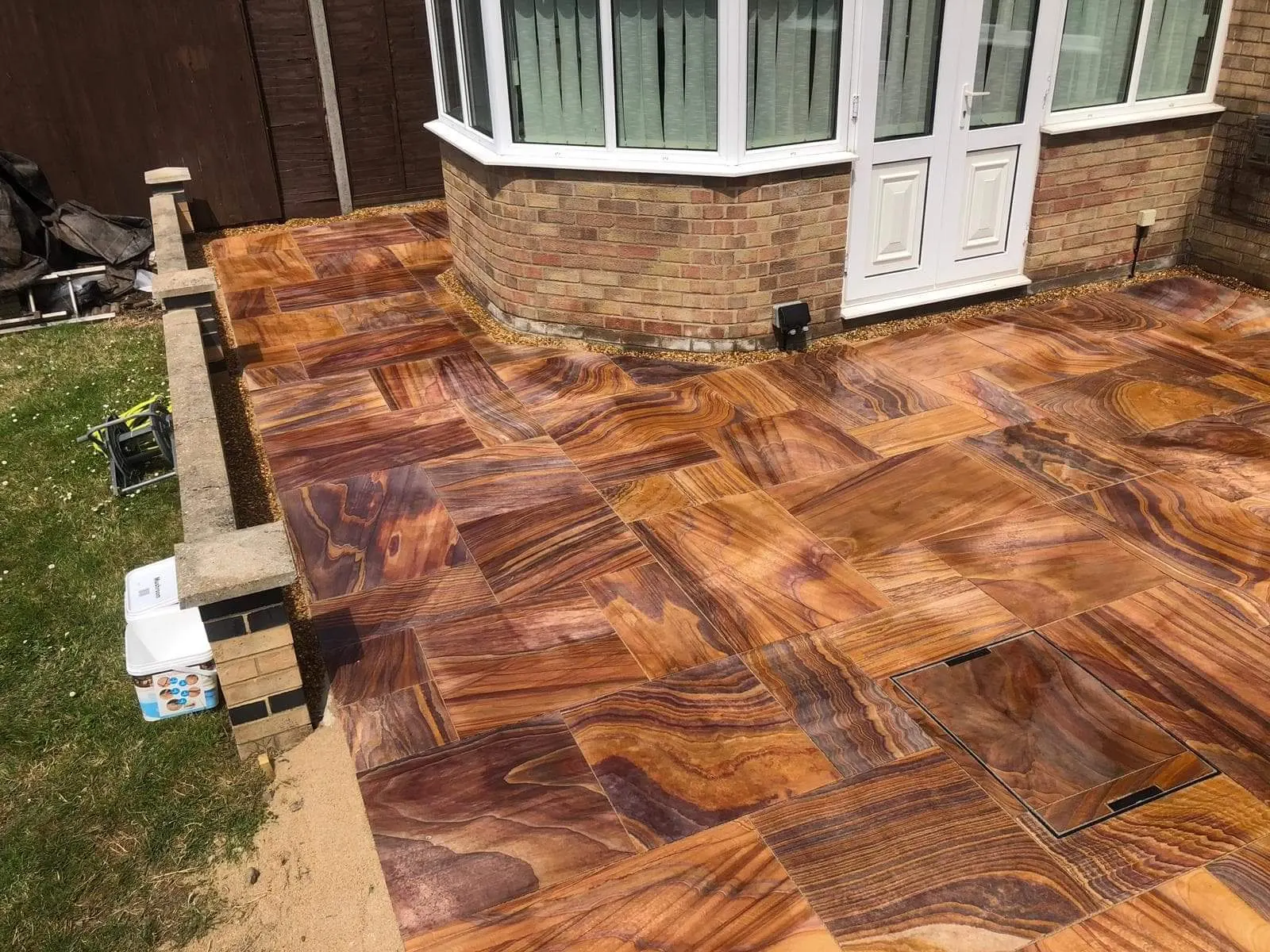 Teak sandstone patio outside a conservatory