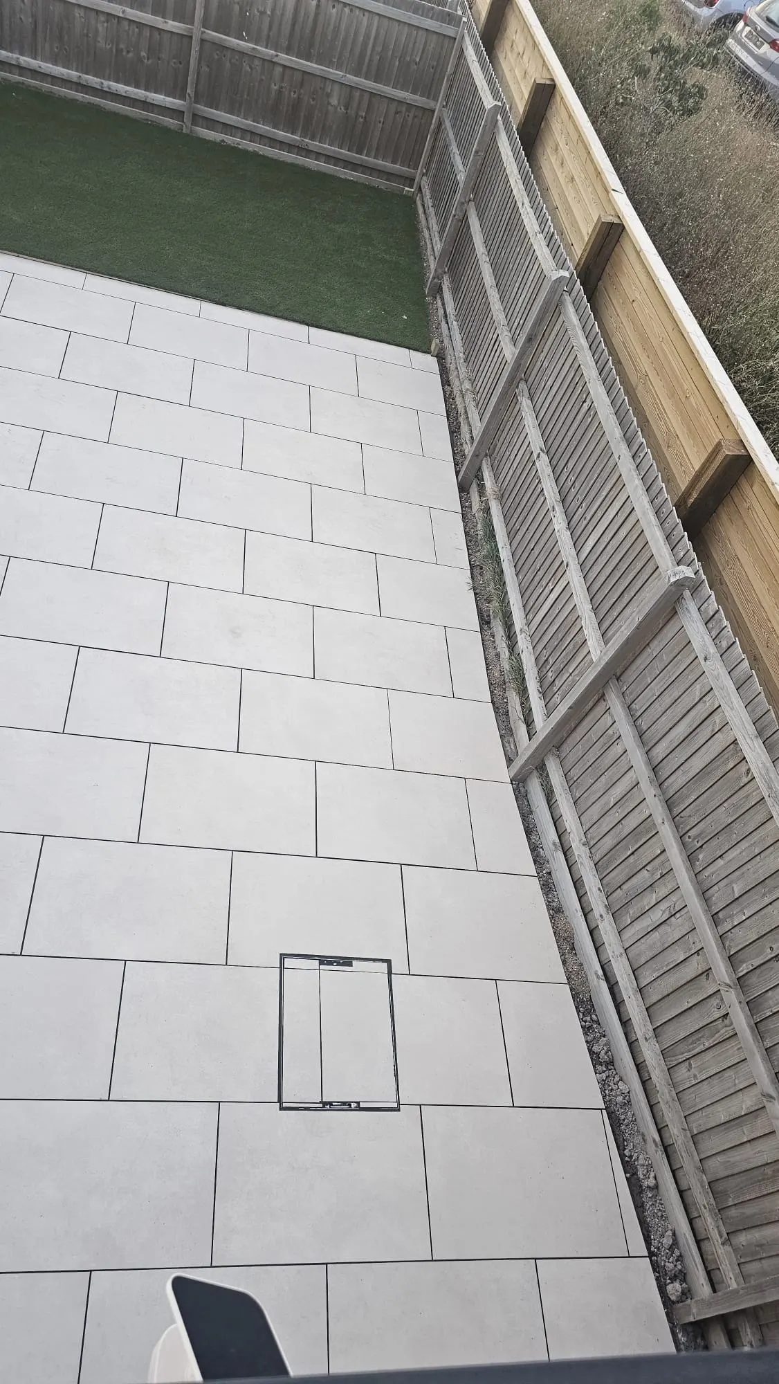 White porcelain patio filling a narrow garden